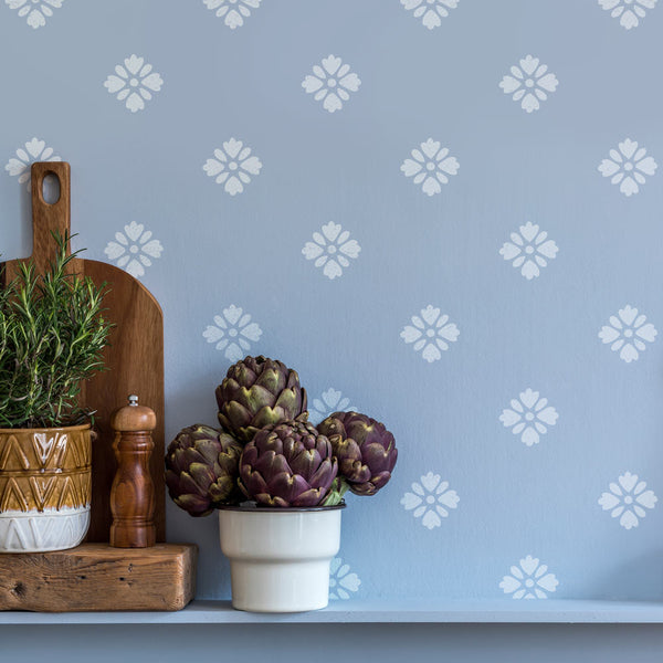 white flower stencil on a blue kitchen wall